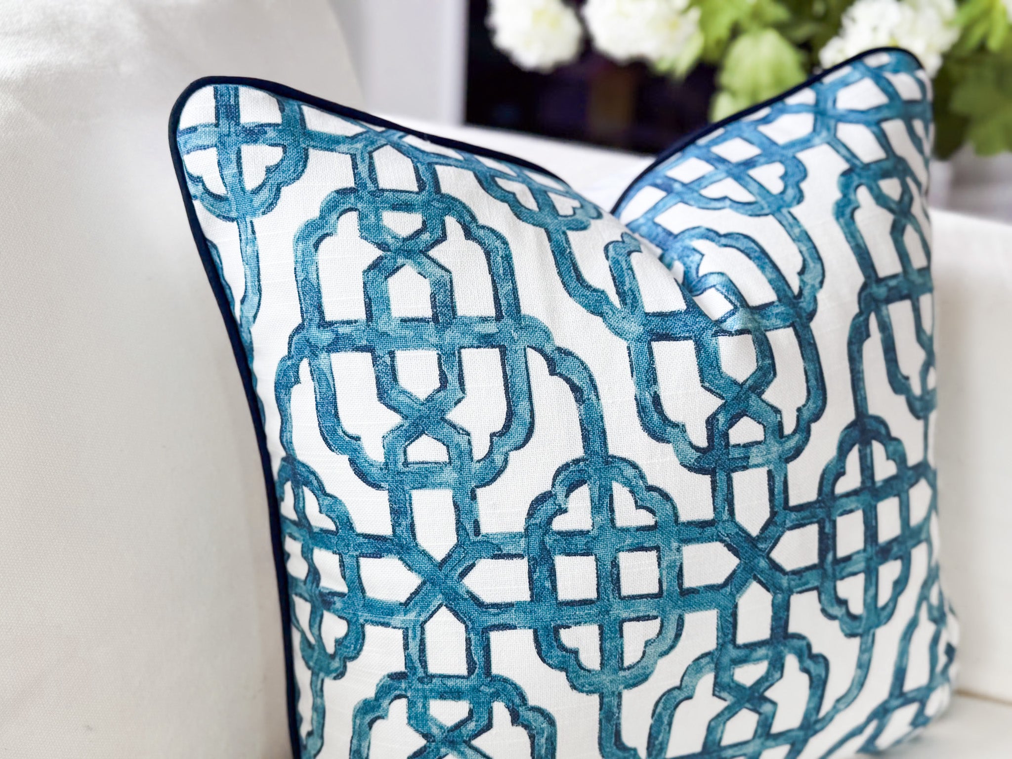 Decorative pillow with blue geometric pattern on a white background