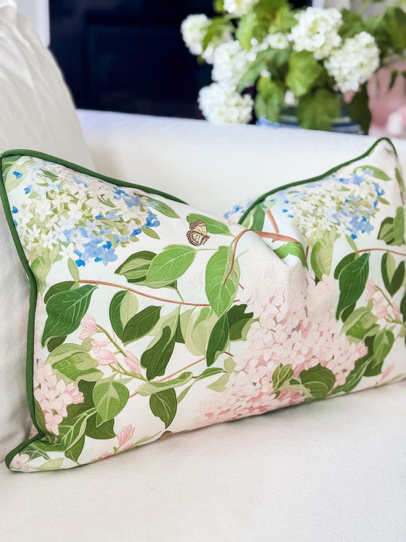 Floral-patterned pillow on a white sofa with a blurred background