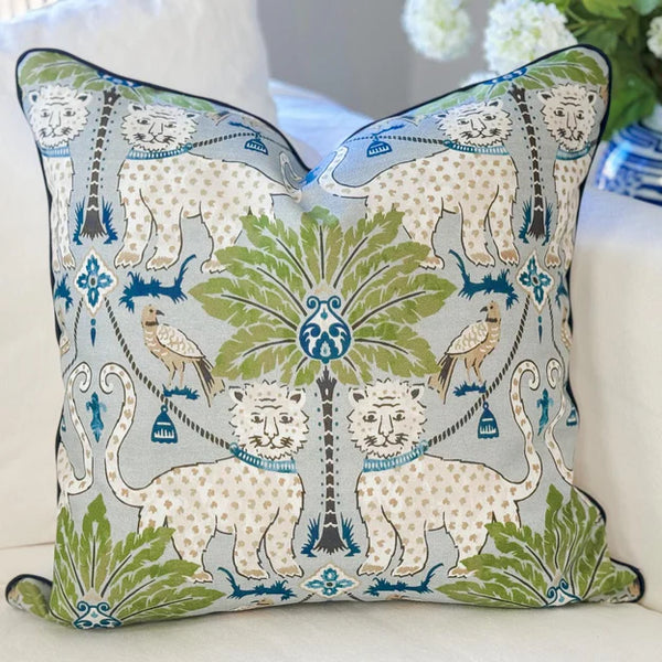 Decorative pillow with jaguar and floral pattern on a white couch